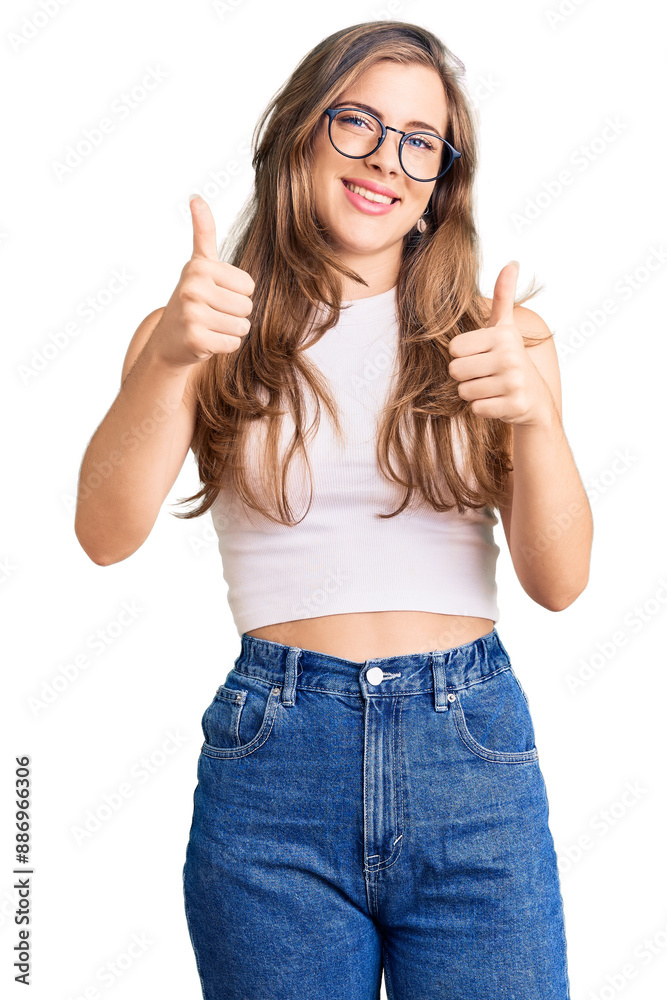 Beautiful caucasian young woman wearing casual clothes and glasses approving doing positive gesture with hand, thumbs up smiling and happy for success. winner gesture. Beautiful caucasian young woman wearing casual clothes and glasses approving doing positive gesture with hand, thumbs up smiling and happy for success. winner gesture.