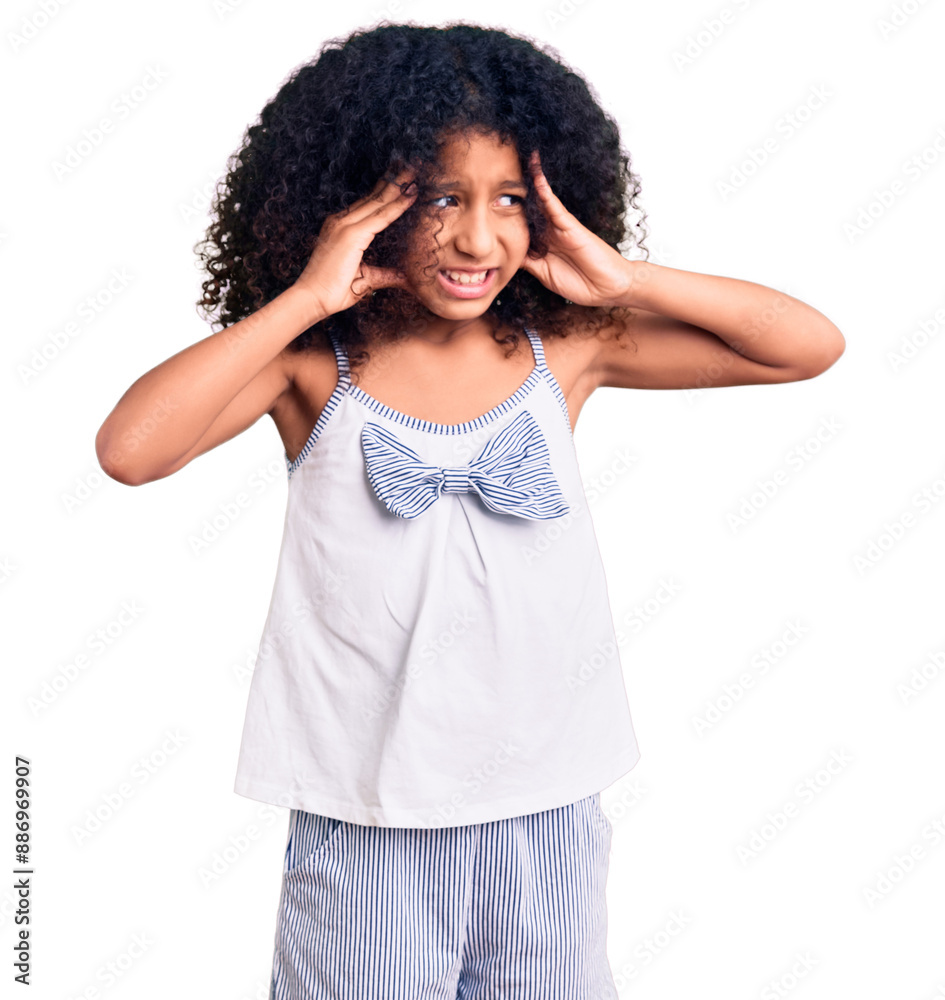 African american child with curly hair wearing casual clothes suffering from headache desperate and stressed because pain and migraine. hands on head.