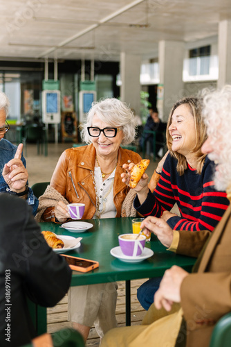 Wallpaper Mural Vertical shot of happy group of senior people laughing and enjoying coffee at cafeteria bar. Retired generation community having fun gathered on terrace toasting hot drink. Torontodigital.ca