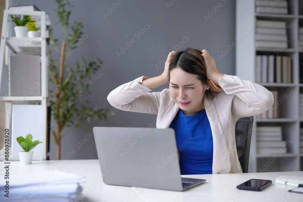Stressed businesswoman at office desk, tired and overworked, navigating tech, feeling pressure and unhappiness, reflecting mental health struggles in corporate settings Stressed businesswoman at office desk, tired and overworked, navigating tech, feeling pressure and unhappiness, reflecting mental health struggles in corporate settings