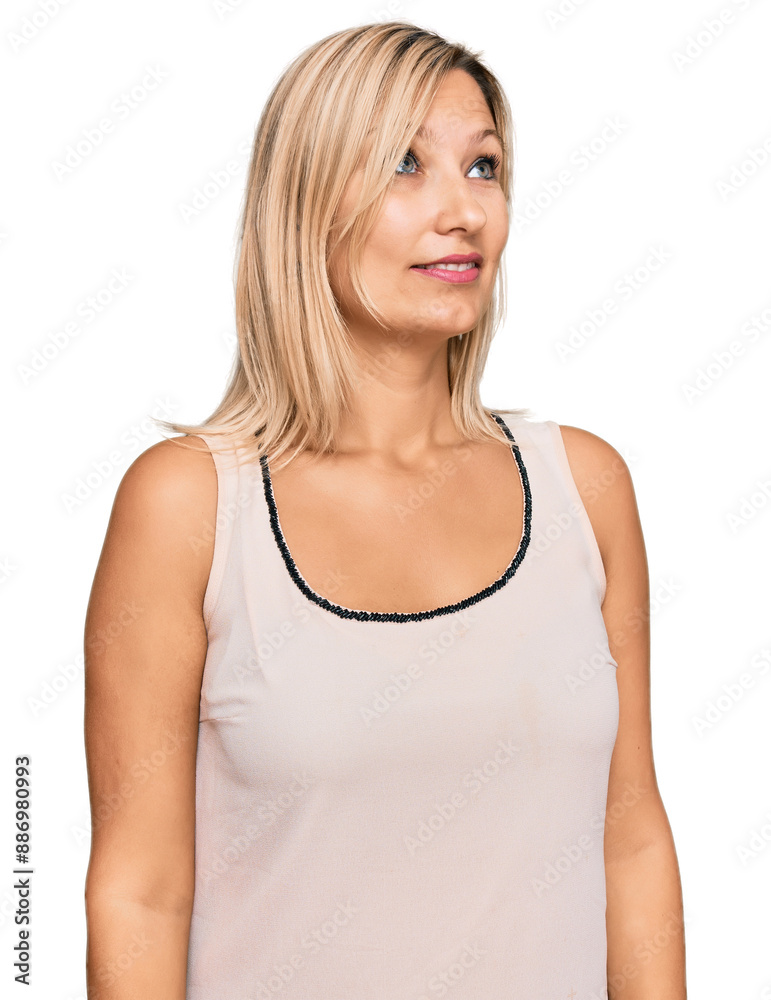 Middle age caucasian woman wearing casual clothes looking away to side with smile on face, natural expression. laughing confident. Middle age caucasian woman wearing casual clothes looking away to side with smile on face, natural expression. laughing confident.