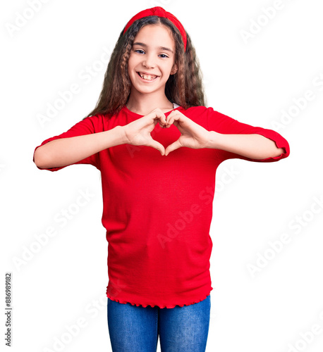 Cute hispanic child girl wearing casual clothes smiling in love showing heart symbol and shape with hands. romantic concept.