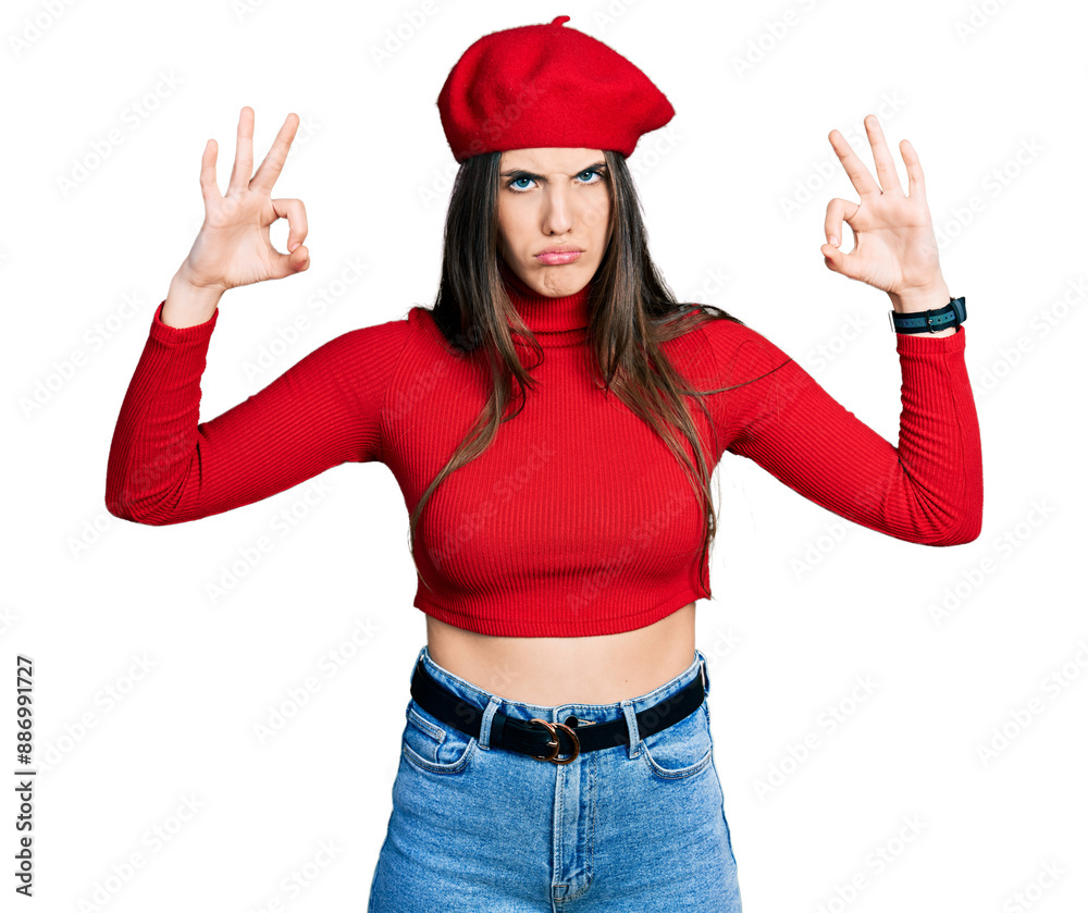 Young brunette teenager doing excellent gesture with hand skeptic and nervous, frowning upset because of problem. negative person. Young brunette teenager doing excellent gesture with hand skeptic and nervous, frowning upset because of problem. negative person.
