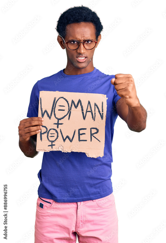 African handsome man holding woman power banner annoyed and frustrated shouting with anger, yelling crazy with anger and hand raised African handsome man holding woman power banner annoyed and frustrated shouting with anger, yelling crazy with anger and hand raised