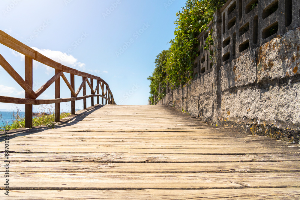 Fototapeta premium Wooden bridge to the beach at the Northern Litoral Natural Park in Galicia, Spain. High quality photo