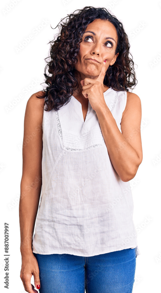 Middle age beautiful woman wearing casual sleeveless t shirt serious face thinking about question with hand on chin, thoughtful about confusing idea Middle age beautiful woman wearing casual sleeveless t shirt serious face thinking about question with hand on chin, thoughtful about confusing idea