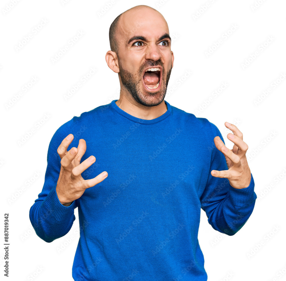 Young hispanic man wearing casual clothes crazy and mad shouting and yelling with aggressive expression and arms raised. frustration concept. Young hispanic man wearing casual clothes crazy and mad shouting and yelling with aggressive expression and arms raised. frustration concept.