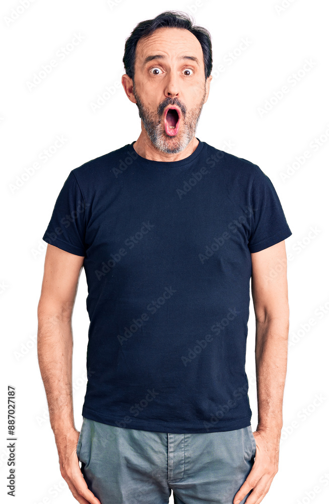 Middle age handsome man wearing casual t-shirt afraid and shocked with surprise expression, fear and excited face. Middle age handsome man wearing casual t-shirt afraid and shocked with surprise expression, fear and excited face.