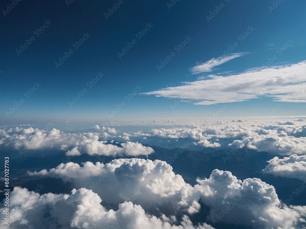 Idyllic view of pristine blue sky and fluffy clouds Idyllic view of pristine blue sky and fluffy clouds
