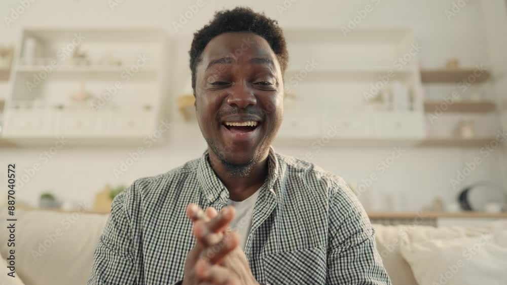 Video call concept, portrait of African man smiling to camera, waving hand. Young black guy greeting interlocutor, say Hi and Hello, distant communication by internet, online conferencing and chat