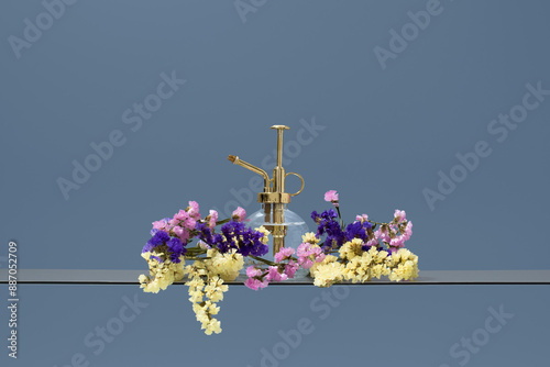 Golden plant mister with colorful Limonium sinuatum setup