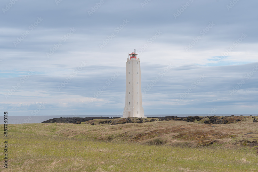 View of Malarrif Lighthouse at Snaefellsnes Penisula in Iceland with blue sky in background.
View of Malarrif Lighthouse at Snaefellsnes Penisula in Iceland with blue sky in background.