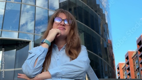 Young sad angry frustrated businesswoman standing outdoors near office building. Job, career problems.