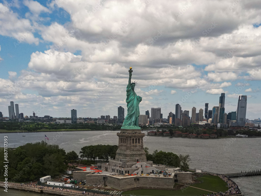 Fototapeta premium The Statue of Liberty over the Panorama of New York cityscape. Symbol of USA. New York city skyline with statue of liberty. The statue of Liberty and Manhattan. Symbol of NYC.