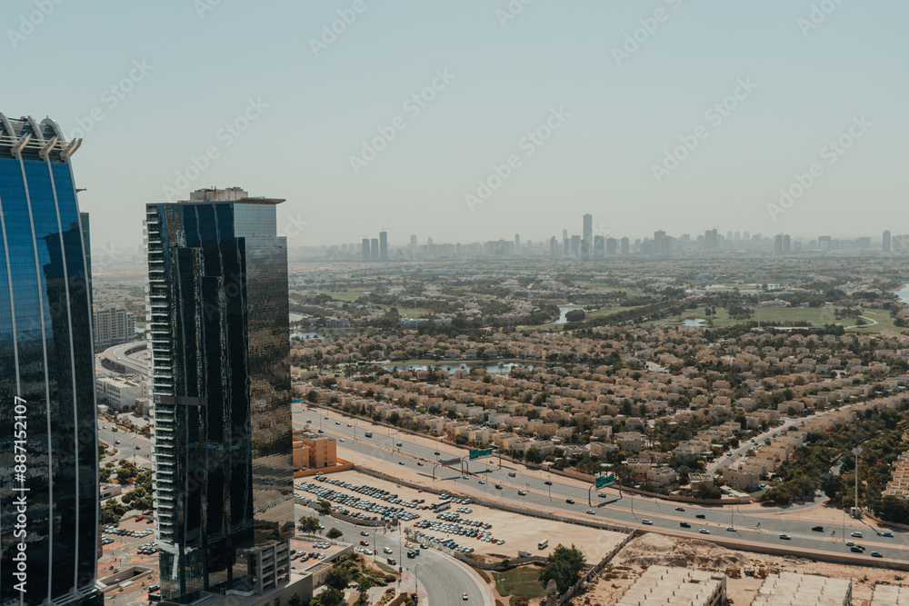 Obraz premium Urban city view with a highway and skyscrapers on the background of blue sky
