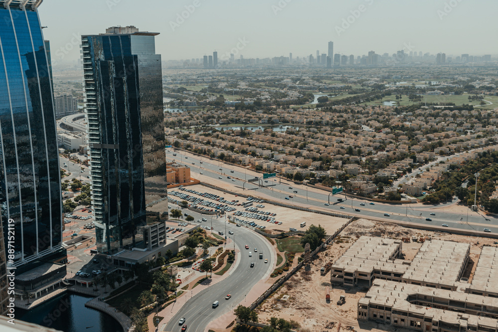 Obraz premium Urban city view with a highway and skyscrapers on the background of blue sky