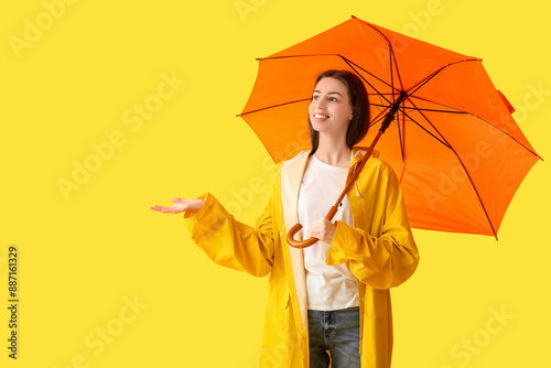 Young happy woman in rainco...