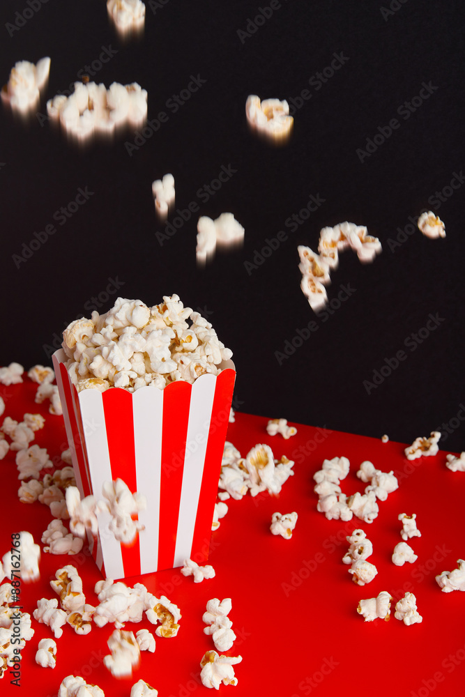 Striped box with popcorn on a red and black background