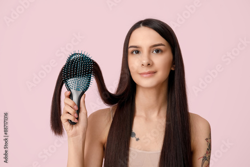 Beautiful young woman brush...