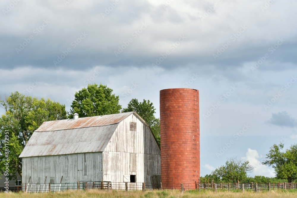 White Barn and Silo in a Farm Field White Barn and Silo in a Farm Field