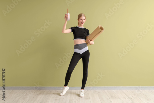 Happy sporty young woman wi...