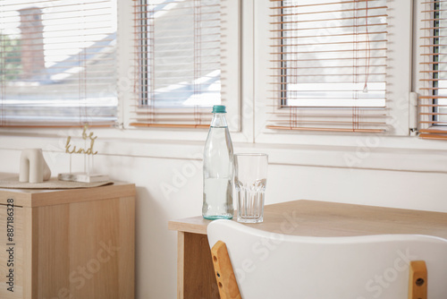 Bottle of water with glass ...