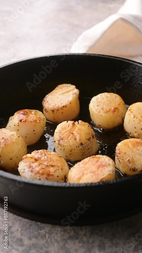 cooking sclallop on iron skillet pan