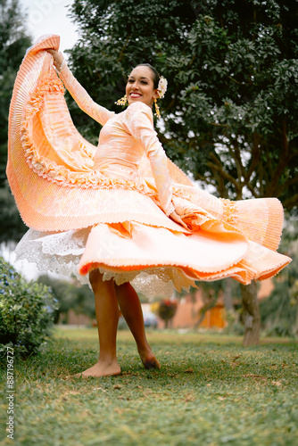 Dancer performing peruvian marinera dance in the park photo