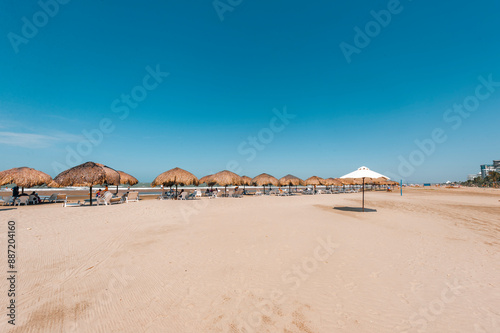 Straw umbrella on La Boquilla beach in Cartagena, Colombia