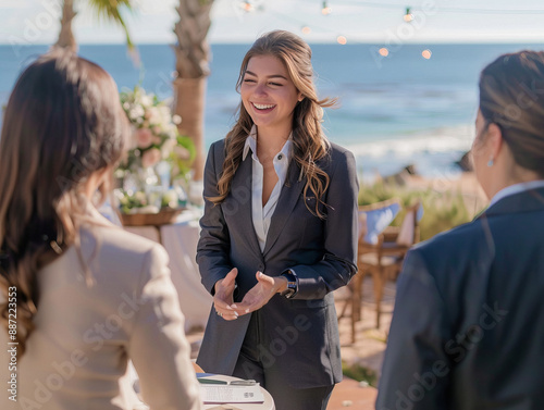 Business style dress woman talking to people at an outdoor meeting or party in tropics by the beach
