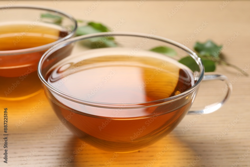 Refreshing green tea in cups on wooden table, closeup Refreshing green tea in cups on wooden table, closeup