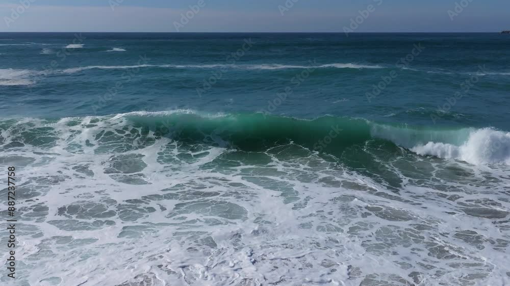 Aerial shot of rough stormy waves over the foamy surface during the daytime. Aerial shot of rough stormy waves over the foamy surface during the daytime.