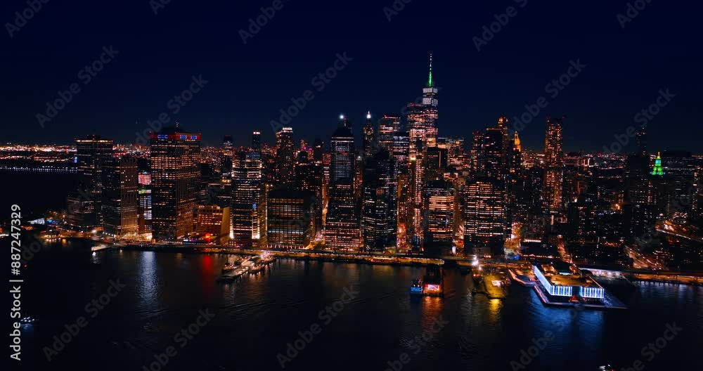 Dazzling scenery of Manhattan, New York, United States at night. Drone flies over the East River approaching the luminous waterfront. Dazzling scenery of Manhattan, New York, United States at night. Drone flies over the East River approaching the luminous waterfront.