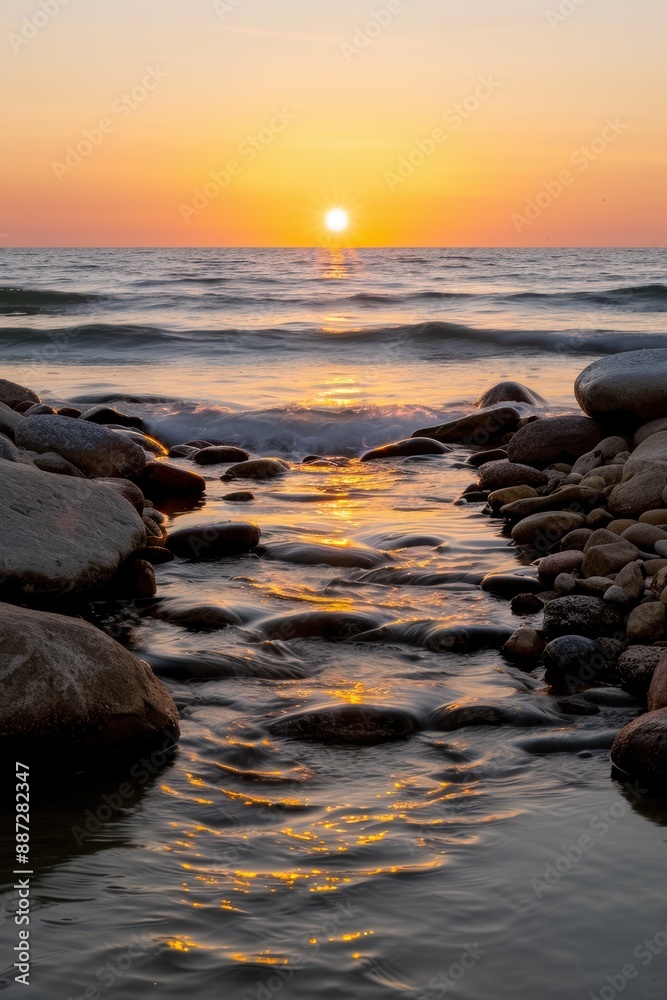 Serene sunset over the ocean with rocky coastline Serene sunset over the ocean with rocky coastline