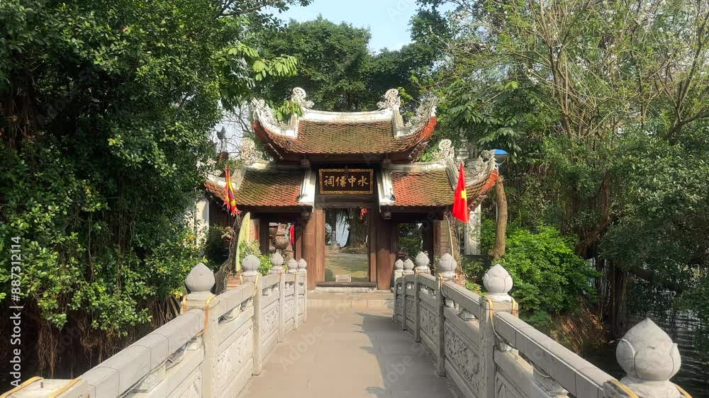 Bridge to a temple. Entrance to a Buddhist temple. Thuy Trung Tien temple. Truc Bach Lake. Ha Noi, Vietnam.