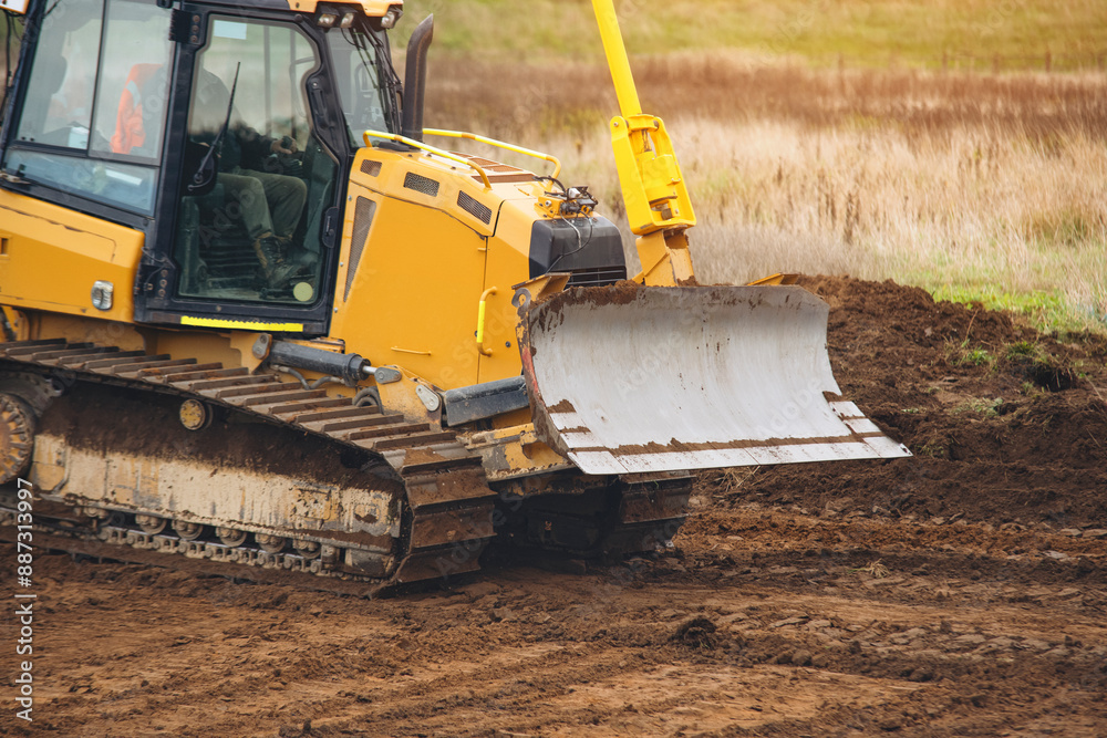Yellow Bulldozer Clearing Land on Construction Site During Day Yellow Bulldozer Clearing Land on Construction Site During Day