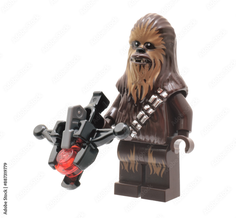 Naklejka premium Lego minifigure of Chewbacca Star Wars Character with weapon isolated on white. Editorial illustrative image of popular plastic constructor to 25 Anniversary.