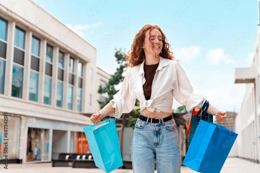 Happy Woman Walking With Shopping Bags In City On Sunny Day Happy Woman Walking With Shopping Bags In City On Sunny Day