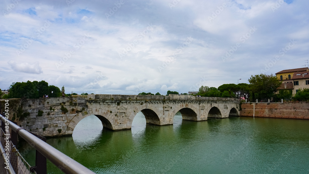 Fototapeta premium Historical roman Tiberius Bridge over Marecchia river in Rimini, Italy