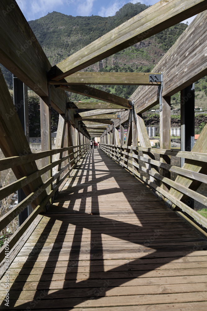 Wooden bridge with shadow over the river Wooden bridge with shadow over the river