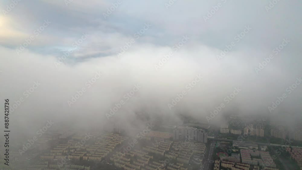 Aerial drone view of landing above white clouds with blue sky background during sunset, 4k fast motion footage b roll shot. Amazing high angle view clouds and city buildings. Aerial drone view of landing above white clouds with blue sky background during sunset, 4k fast motion footage b roll shot. Amazing high angle view clouds and city buildings.
