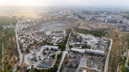 Fototapeta Naklejka Na Ścianę i Meble -  Aerial view of city with open pit mine and industrial area