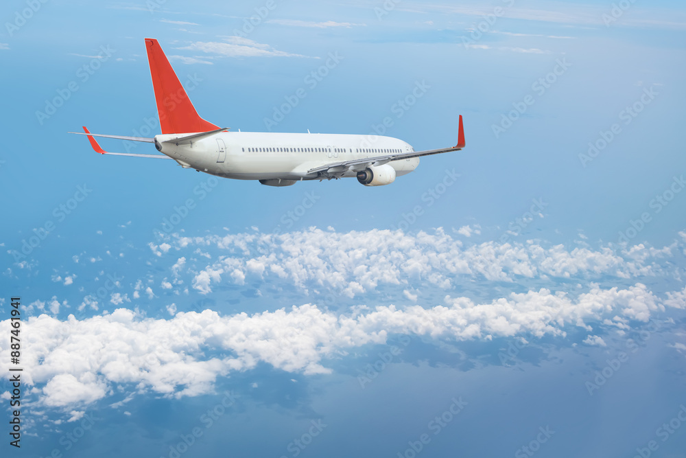 Obraz premium White passenger airplane flying in the sky amazing clouds in the background - Travel by air transport