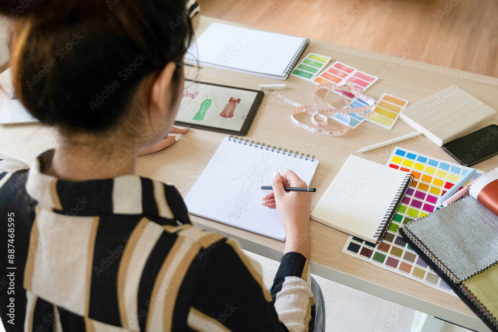 Young clothing designer envisions new ideas in studio.