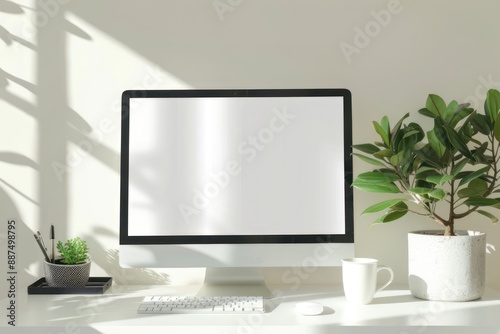 Close up view of creative workspace with blank screen computer  mug  tree pot and copy space