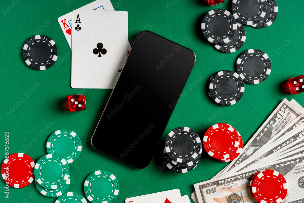 Fototapeta premium Playing Cards, Chips, and Cash on a Green Felt Surface With a Smartphone