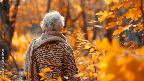 Senior woman enjoying a walk in an autumn forest, concept of elderly outdoor activity, leisure in nature, fall season. Copy space