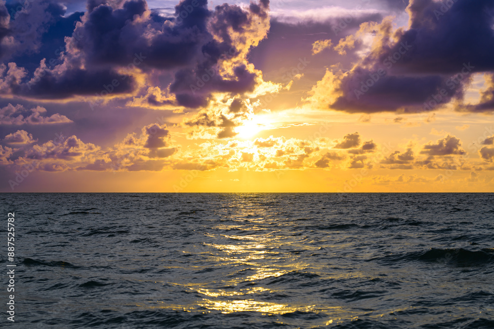 Obraz premium Colorful dramatic sky. Big cloud above ocean. Cloud sky with sea background. Amazing dramatic sky sunset background.