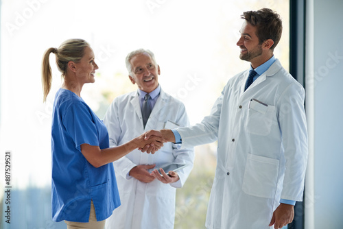 Healthcare, teamwork and medical people with handshake for greeting, introduction and welcome with smile. Hospital, nurse and resident physician with shaking hands for onboarding, training and hello