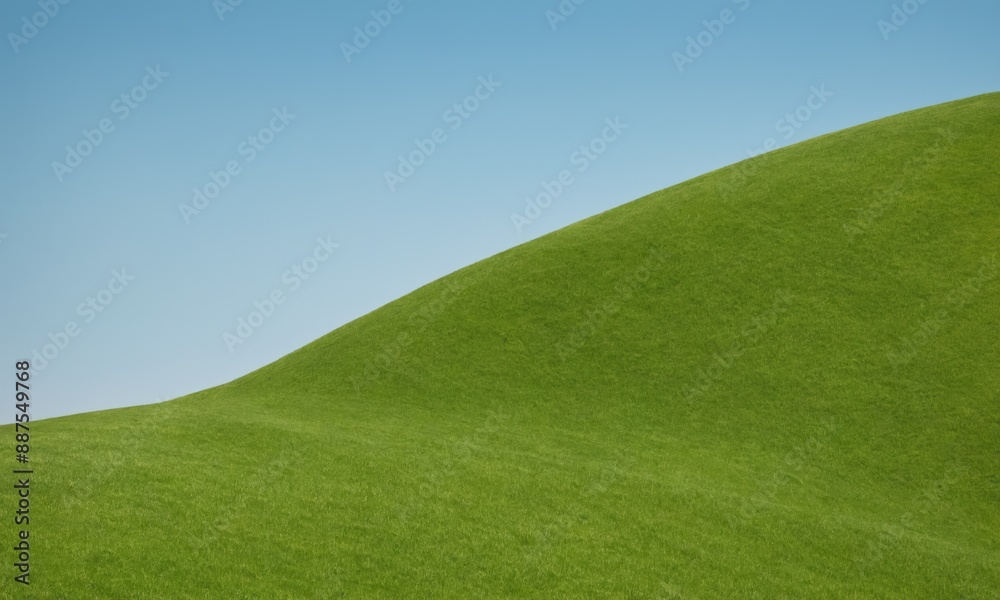 Fototapeta premium Zielone, trawiaste wzgórze na tle błękitnego nieba